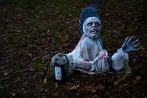 a statue of a person with a bottle of water in a yard