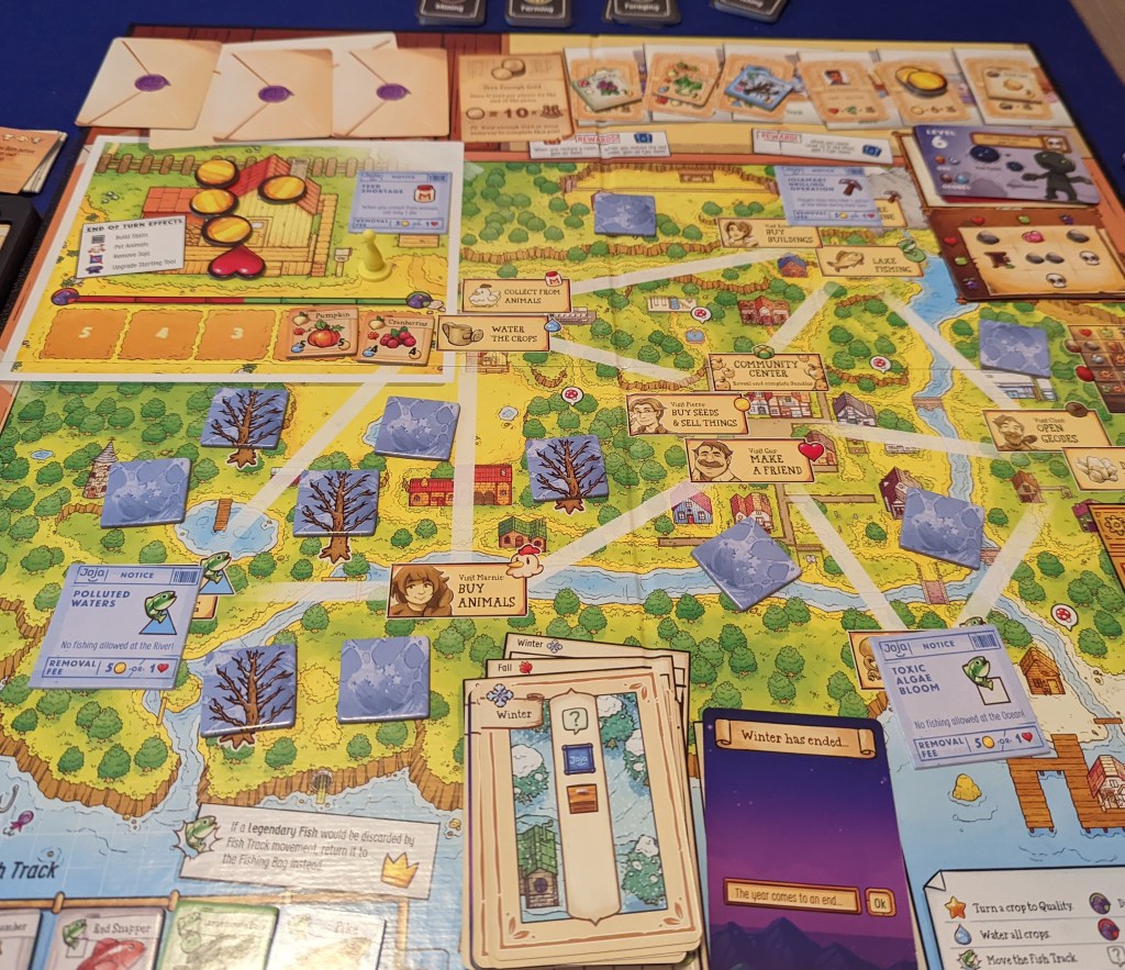 smartfon z appką AI obok rozłożonej gry planszowej na stole